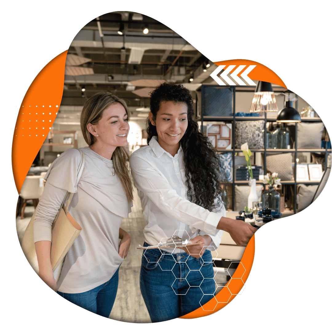 Two women shopping in a furniture store.
